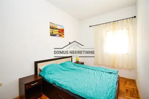 Furnished bedroom with a double bed, bedside tables, and a window. - image 7