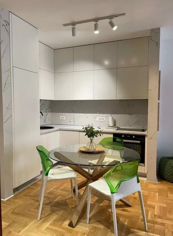 Modern kitchen with a dining table and chairs.