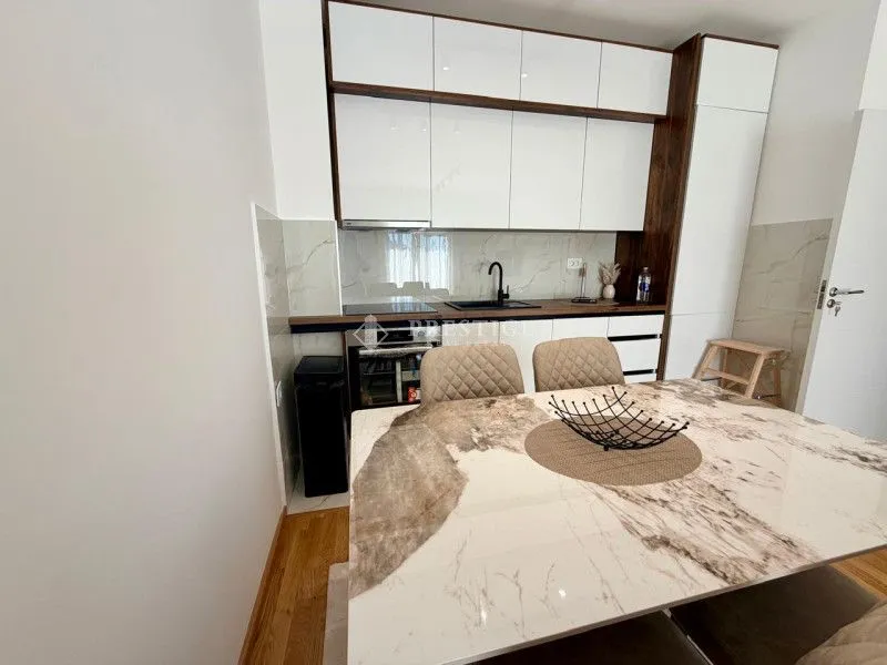 Modern kitchen with a dining table and chairs.