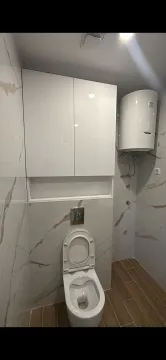 Modernly equipped bathroom with built-in units and a water heater. - image 2