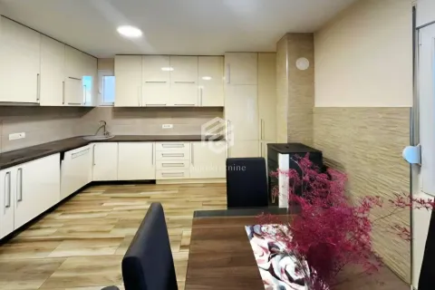 Kitchen with white cabinetry and an adjoining dining table. - image 2