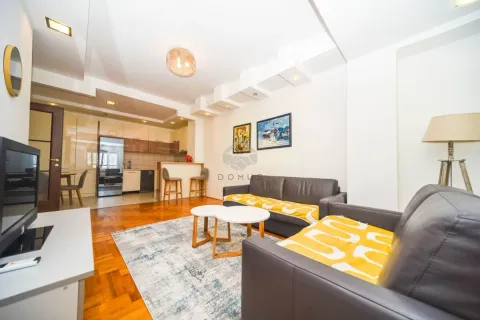 Living room with a sofa set and a view of the kitchen in the background. - image 3