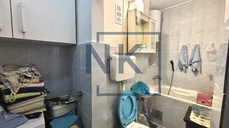 Smaller bathroom with a bathtub, toilet, and sink.