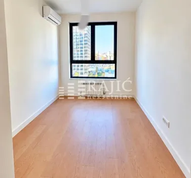 Empty room with wooden flooring and a window. - image 5