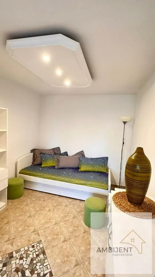 Furnished bedroom with a bed and decorative elements.