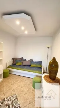 Furnished bedroom with a bed and decorative elements. - image 3
