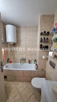 Bathroom equipped with a bathtub, washbasin, and toilet, finished with ceramic tiles. - image 11