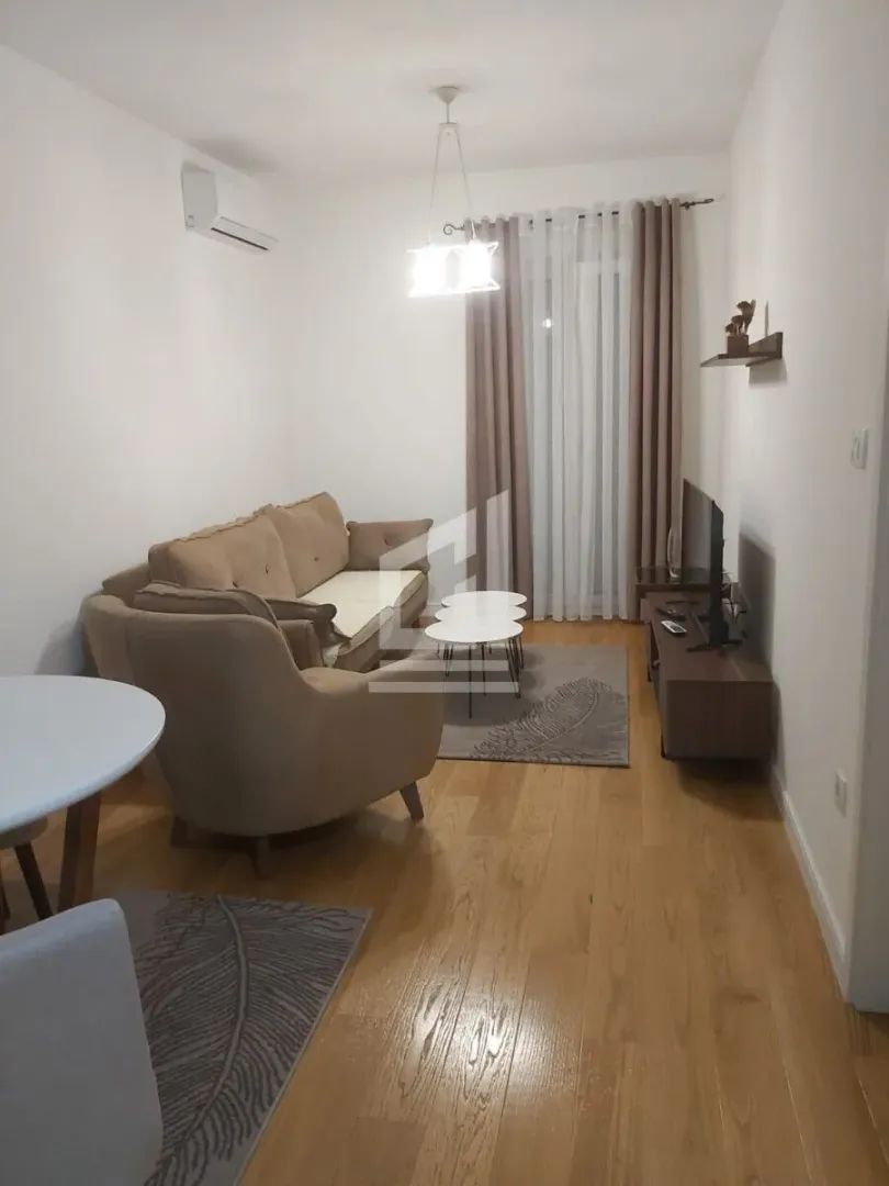 Living room with sofa, armchair and TV unit.