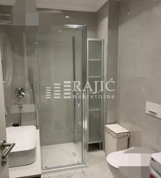 Modern bathroom with a shower cabin, washbasin, and toilet fixtures. - image 11