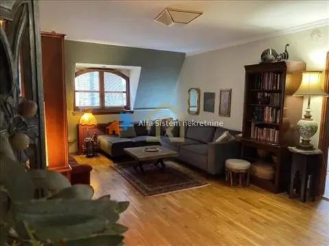 Living room with a sofa set, bookcase, and wooden floor. - image 14