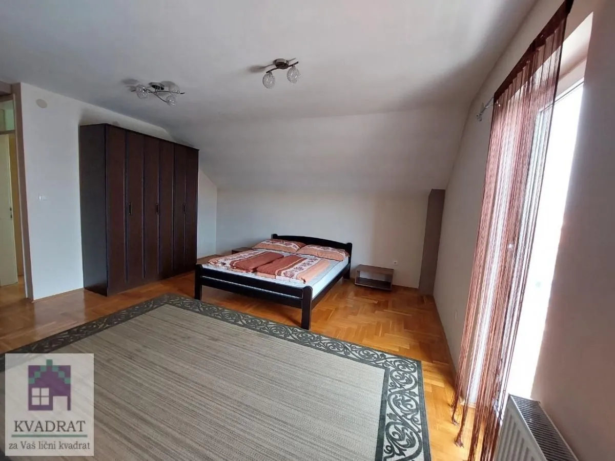 Bedroom with a double bed, large wardrobe, and parquet flooring.
