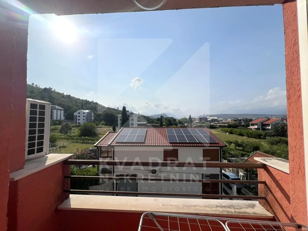 View from the balcony overlooking the surrounding neighborhood and hills.