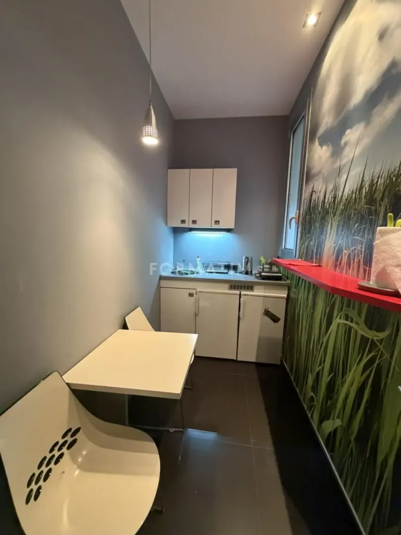 Small kitchen with a dining table and chairs.