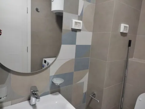 Modern ceramic tiles in a bathroom with a sink and a mirror. - image 10