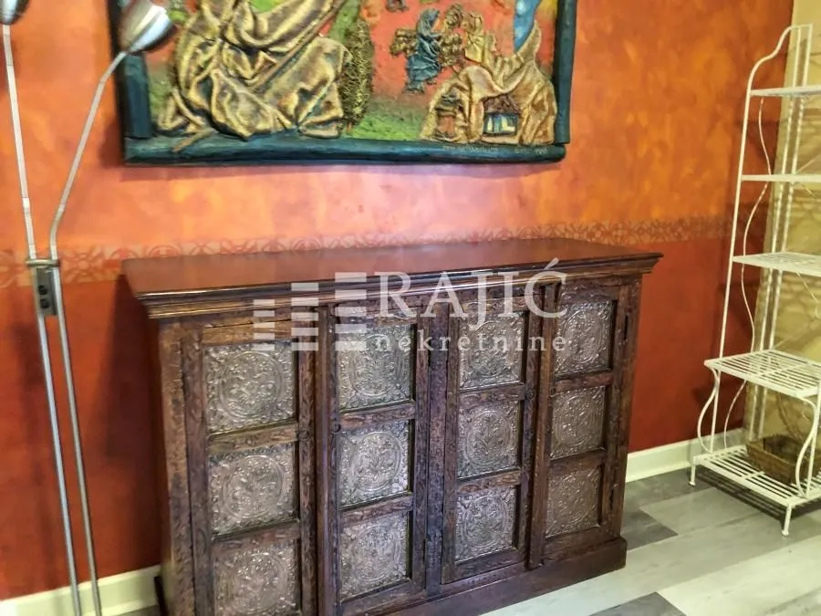Living room with a cabinet and decorative elements.