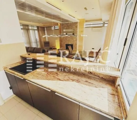 Modern kitchen with a breakfast bar overlooking the living room.
