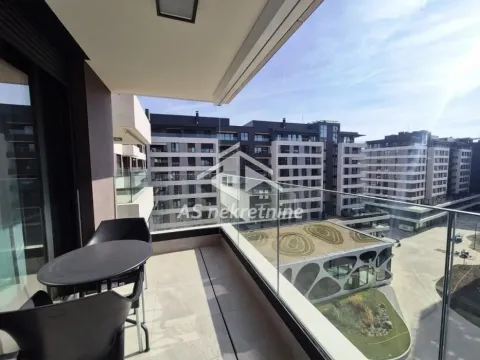 Modern furnished balcony with a table and chairs overlooking the neighborhood. - image 9