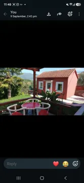 View from the covered terrace towards the yard and a small house. - image 5