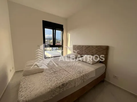 Furnished bedroom with a double bed and a window. - image 7