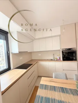 Modern kitchen with white cabinets and a wooden countertop. - image 3