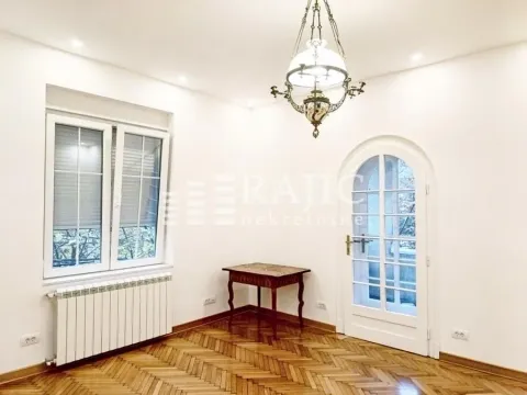 Empty room with parquet flooring, white walls, and a decorative chandelier. - image 4