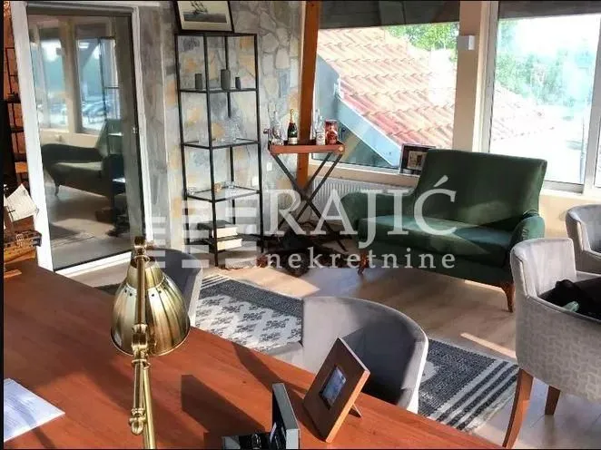 Living room with sofa set and dining table.