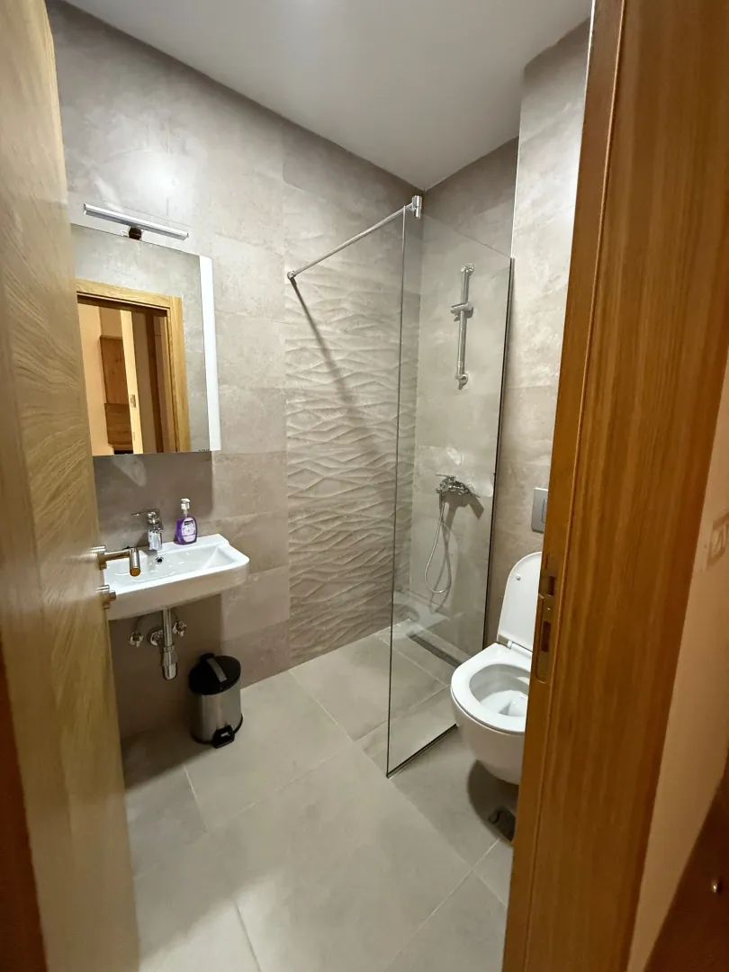 Modernly equipped bathroom with a walk-in shower.
