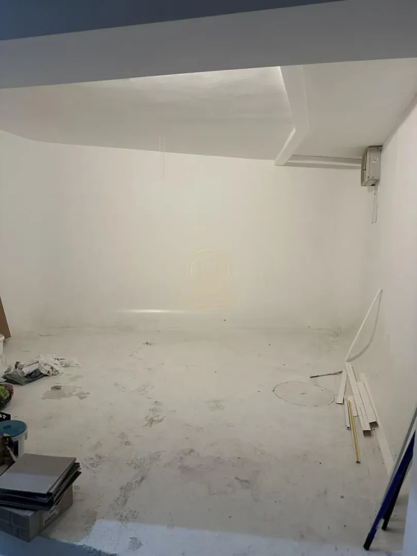 Empty room during renovation with white walls.