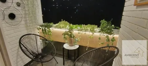 Nicely decorated terrace with chairs and greenery at night. - image 2