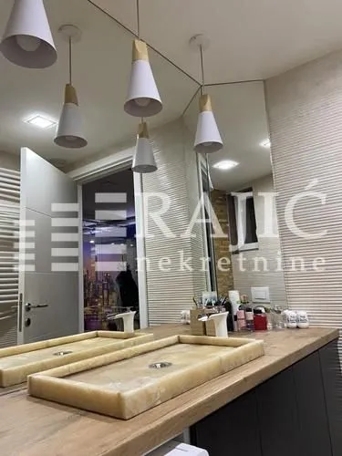 Modern bathroom with two sinks and a mirror.
