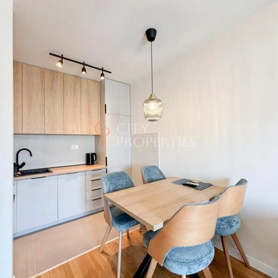 Small kitchen with a dining table and chairs.