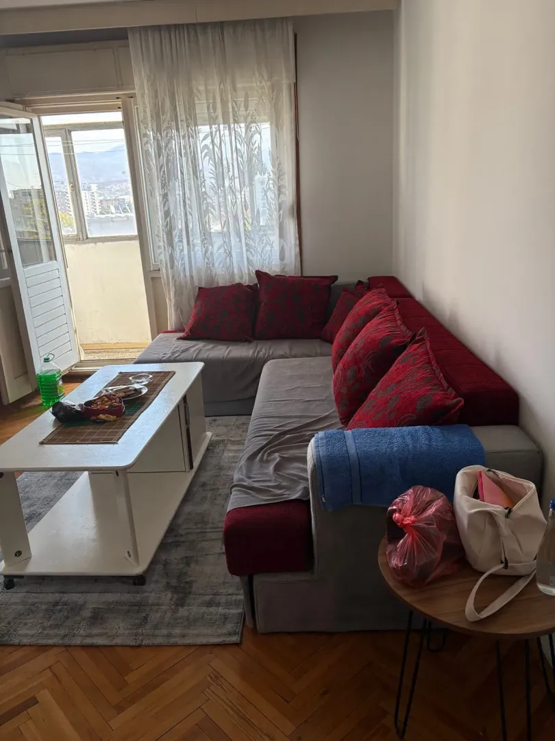 Living room with a corner sofa, coffee table, and access to the balcony.
