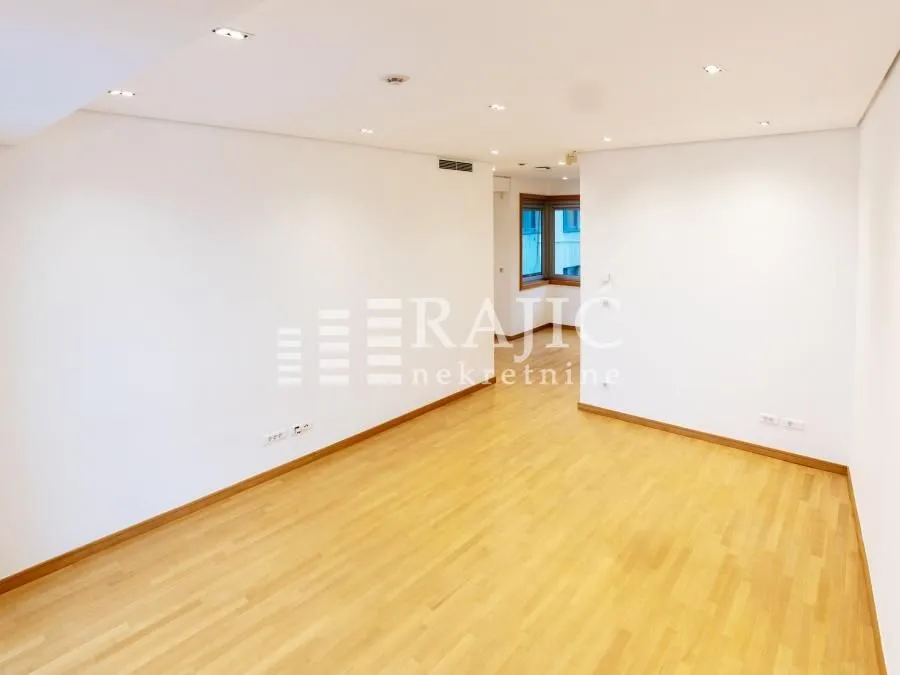 Empty bright room with wooden flooring.