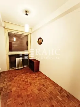 Empty room with parquet flooring and a window. - image 13