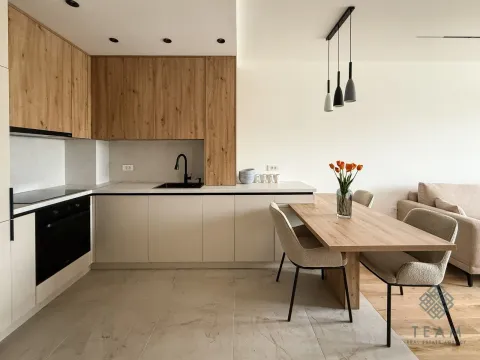 Modern kitchen with wooden elements and a dining area. - image 3