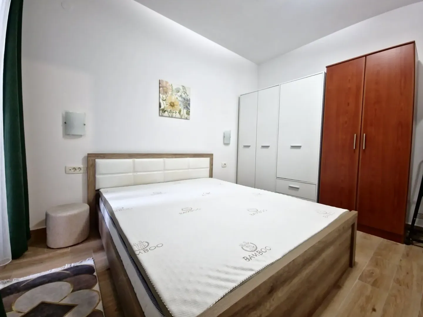 Furnished bedroom with a double bed and wardrobes.