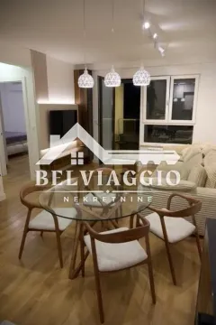 Living room with dining area, sofa and TV. - image 6
