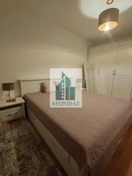 Bedroom with a double bed, wardrobe, and bedside tables. - image 10