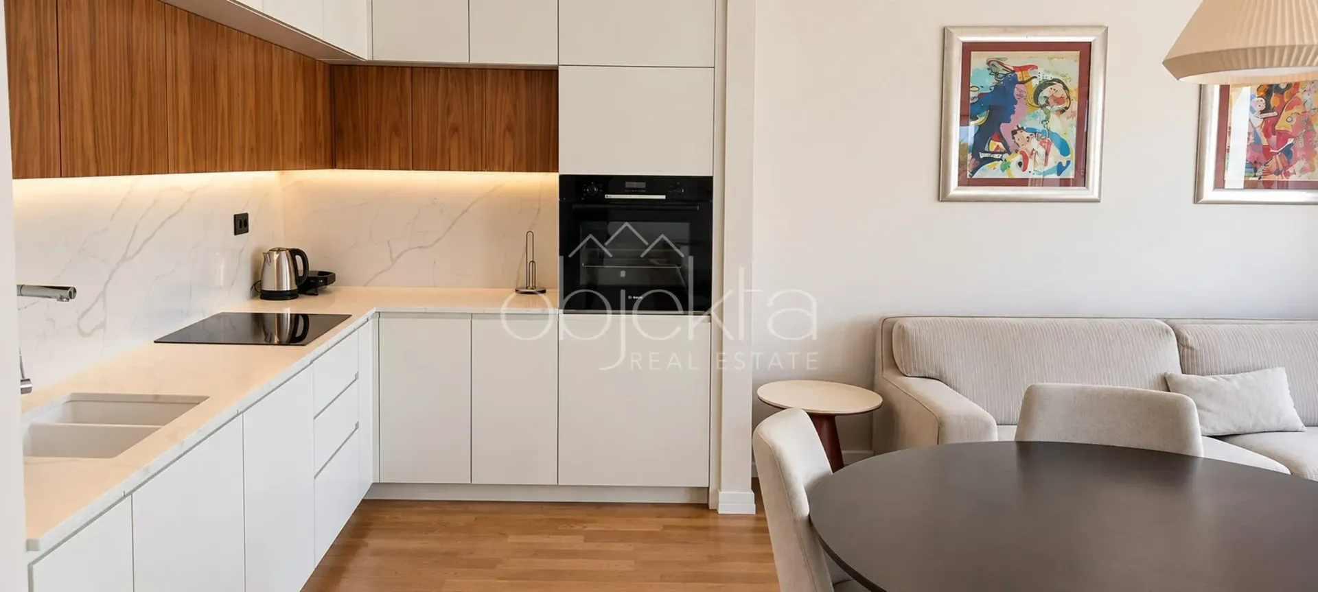 Modern kitchen connected to the dining area and living room.