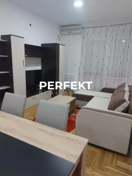 Living room with a sofa set, TV unit, and dining table. - image 6