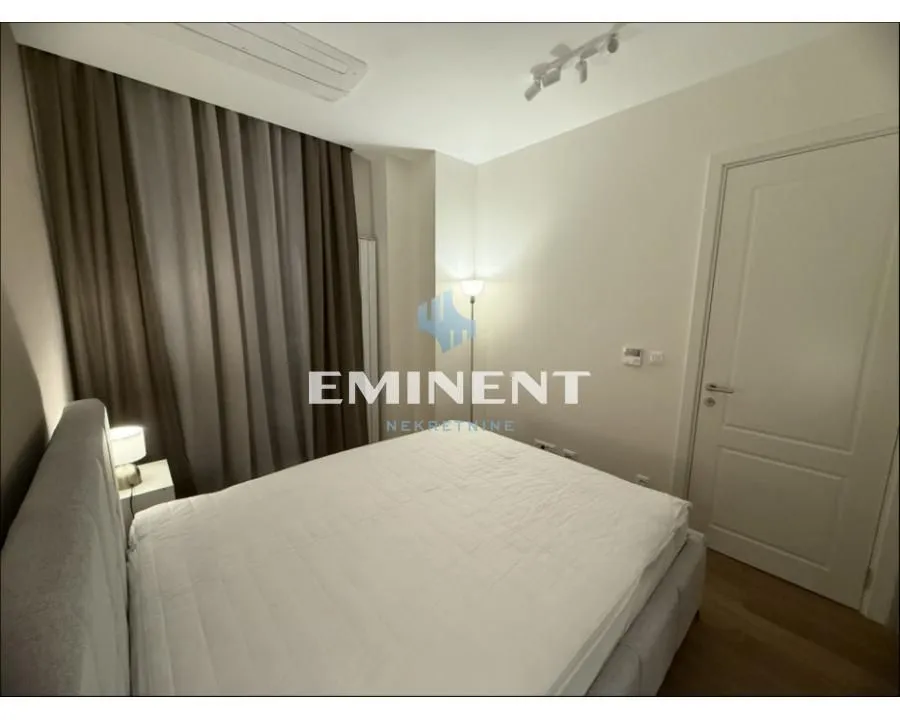 Bedroom with a double bed and dark curtains.