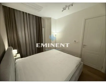 Bedroom with a double bed and dark curtains. - image 10