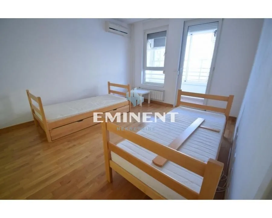 Bedroom with two wooden beds and access to the terrace.