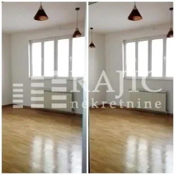 Empty room with hardwood floors and windows. - image 2