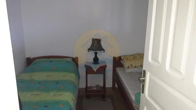 Bedroom with two single beds and a bedside table.