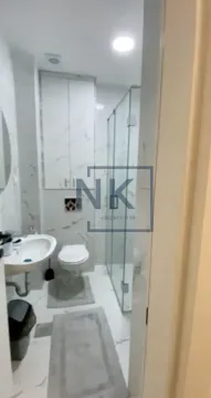 Modern bathroom with a walk-in shower, washbasin, and toilet. - image 10