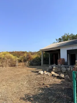 View of the yard and the exterior of a house under construction. - image 10