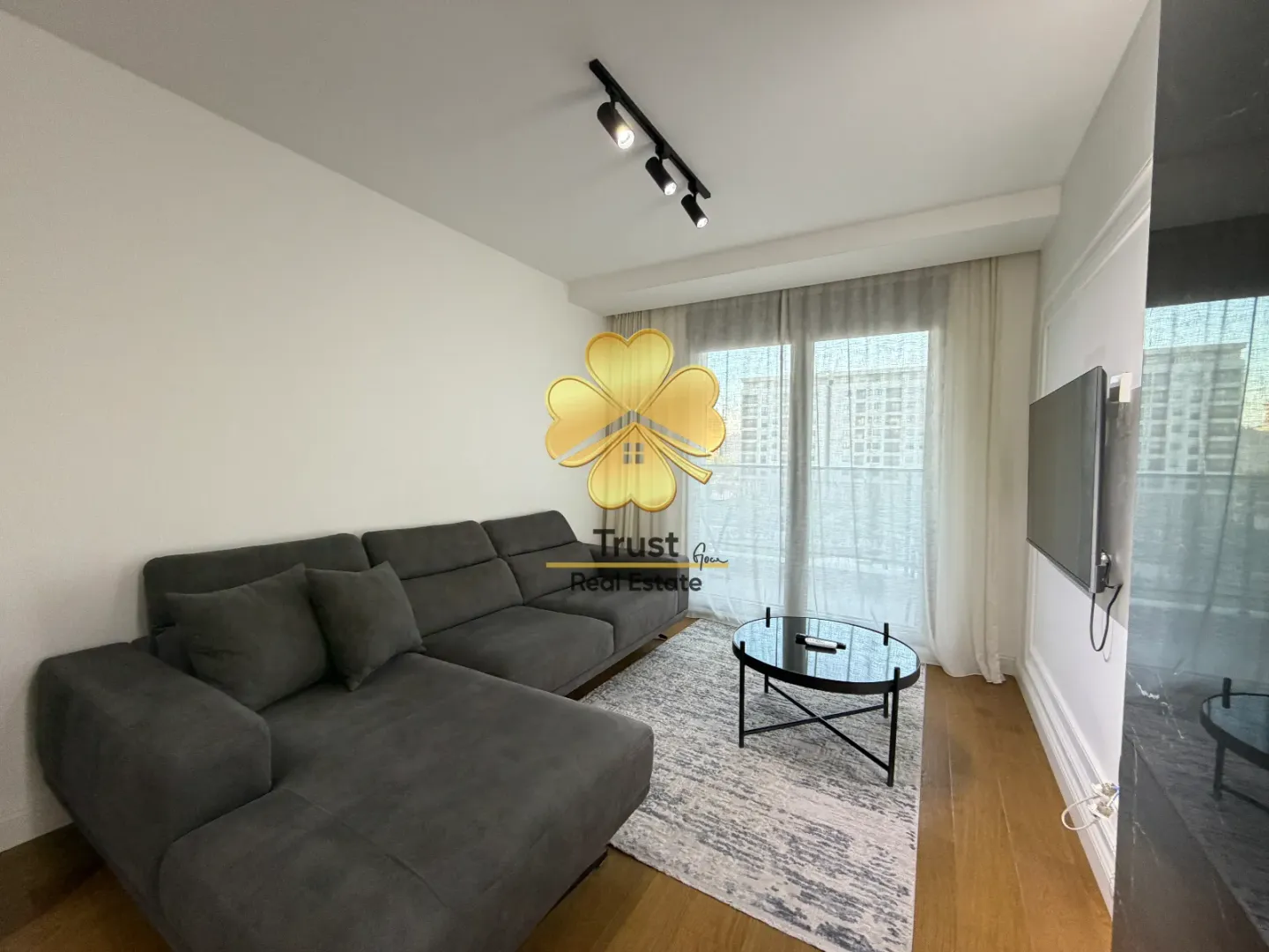 Living room with a sectional sofa, coffee table, and TV.