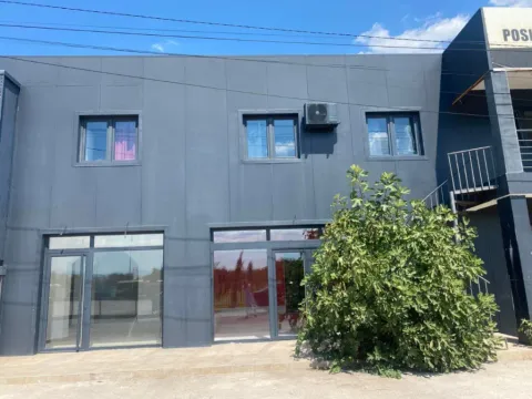Exterior view of a commercial building with a dark facade. - image 4