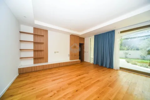 Empty living room with wooden flooring, built-in shelving, and large glass doors leading to the yard. - image 17